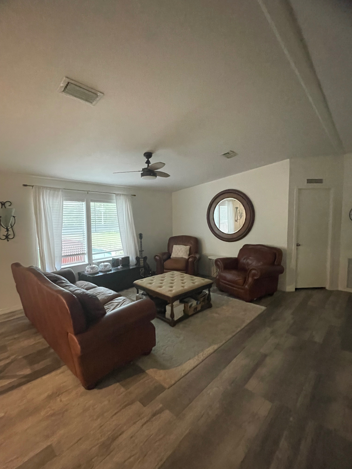 Bright open living room with vaulted ceiling and hardwood floors